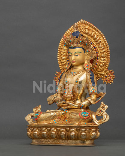 Golden Amitayus statue seated on a lotus pedestal in Dhyana Mudra holding a long-life vase symbolizing longevity.