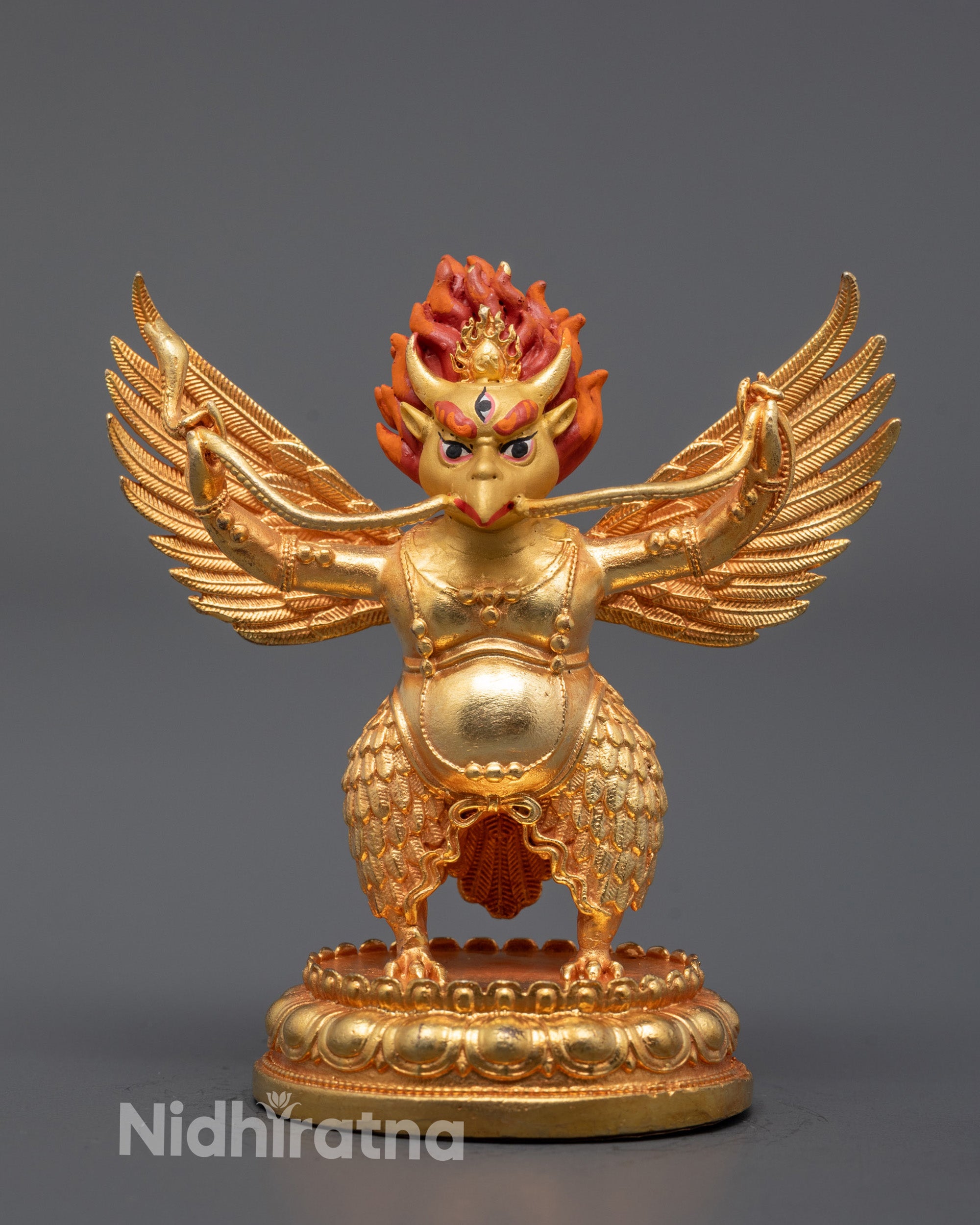 golden-winged garuda statue front view showing commanding stance and third eye detail