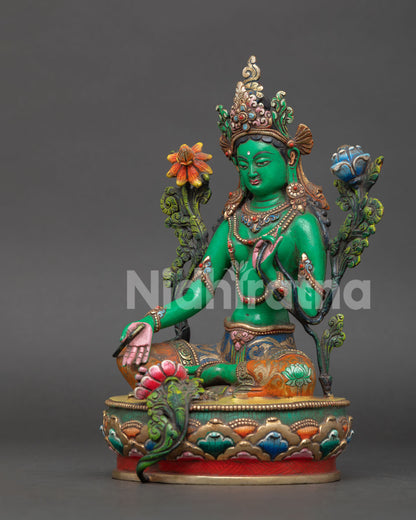 Green Tara Buddhist goddess sculpture in Lalitasana posture with Abhaya Mudra and blue lotus flower