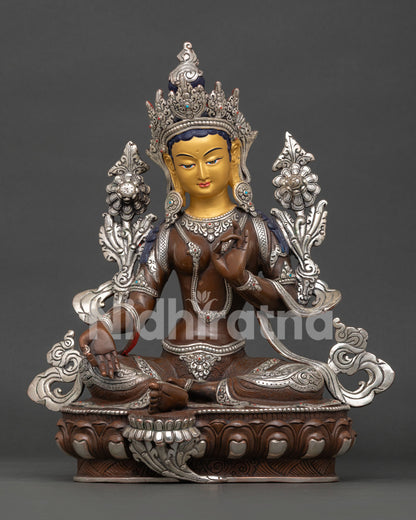 Green Tara Buddhist goddess sculpture seated on lotus throne with turquoise and coral stone adornments symbolizing healing and strength.