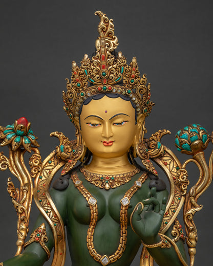 Green Tara Buddhist statue close-up showing turquoise coral inlaid crown and painted details