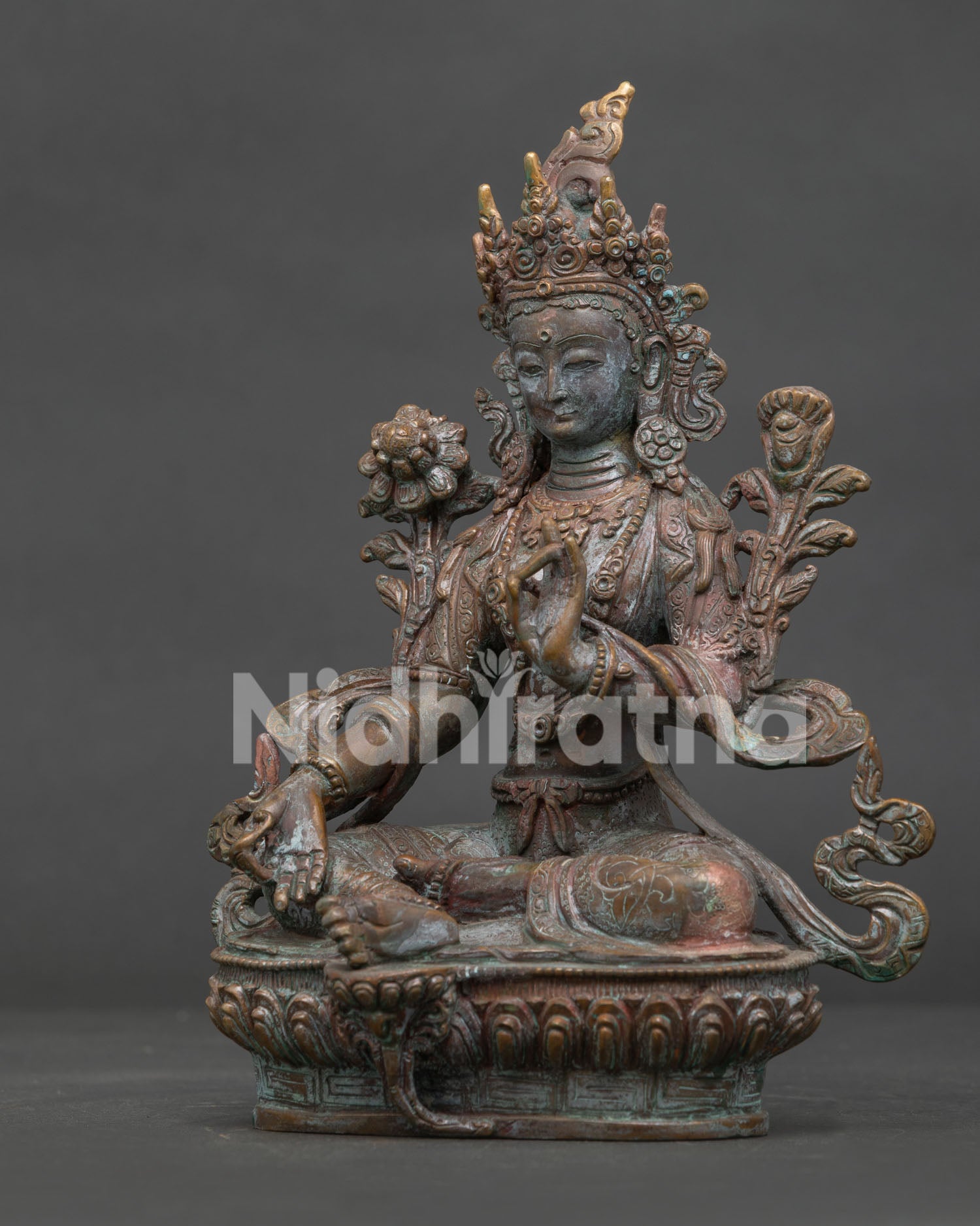 Green Tara Buddhist statue detailed lotus pedestal and traditional Nepalese craftsmanship.