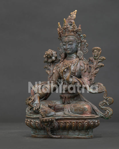 Green Tara Buddhist statue detailed lotus pedestal and traditional Nepalese craftsmanship.