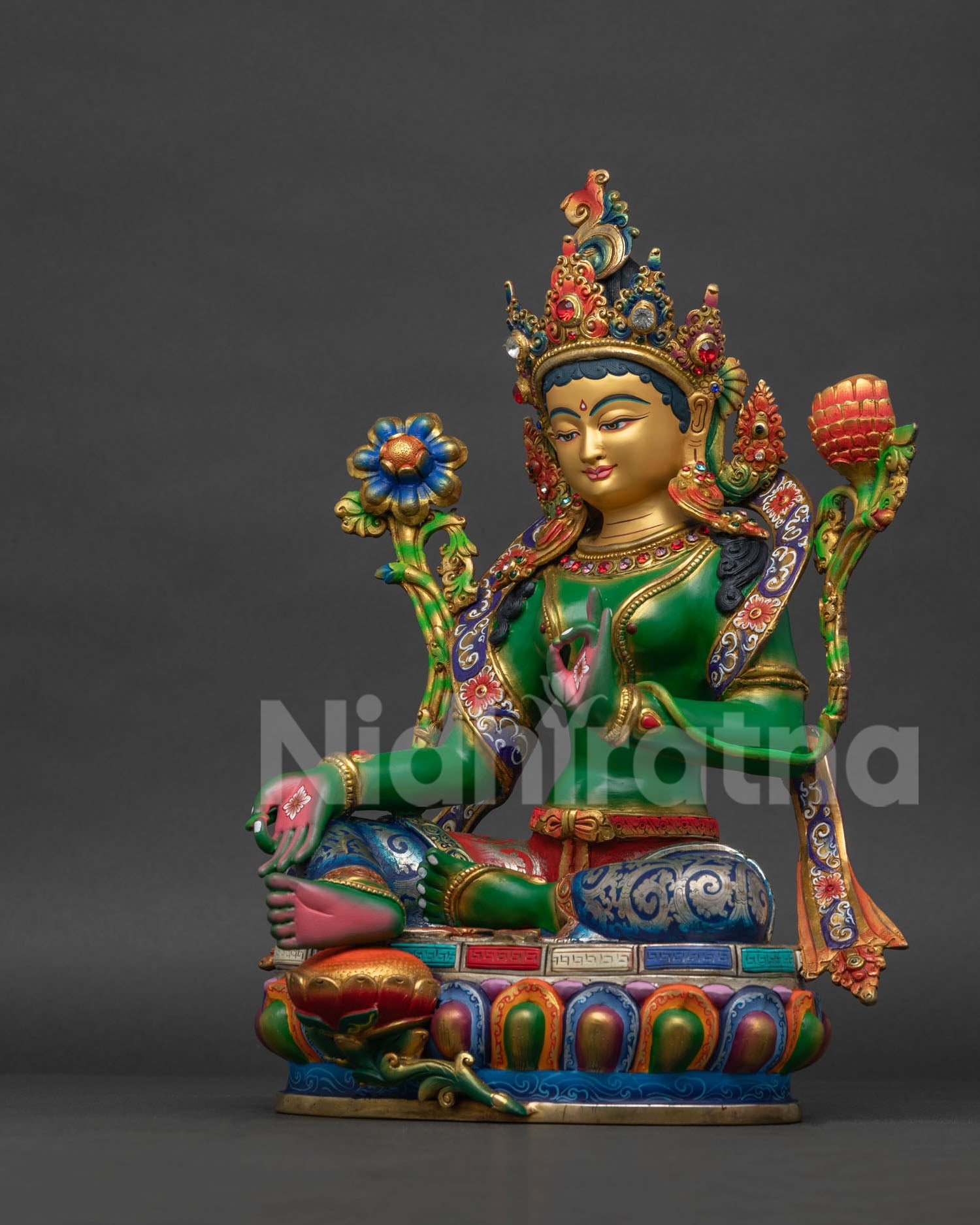Green Tara Buddhist statue left view side showing multicolor robe and silver plated garment