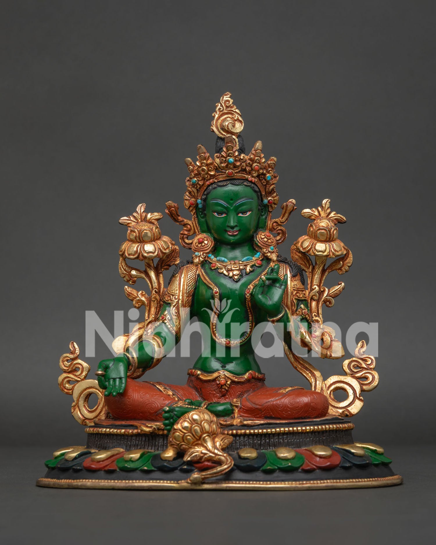 Green Tara Buddhist statue seated on lotus pedestal in royal ease posture