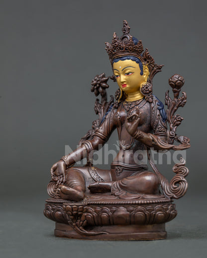 Green Tara Buddhist statue seated on lotus throne with extended leg and traditional Nepalese craftsmanship.