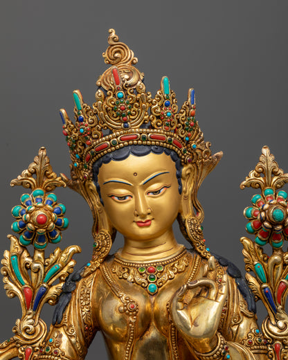 Green Tara Buddhist statue with 24K gold painted face and gemstones.