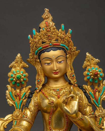 Close up of Green Tara copper statue Thailand showing gold gilding and jeweled crown detail
