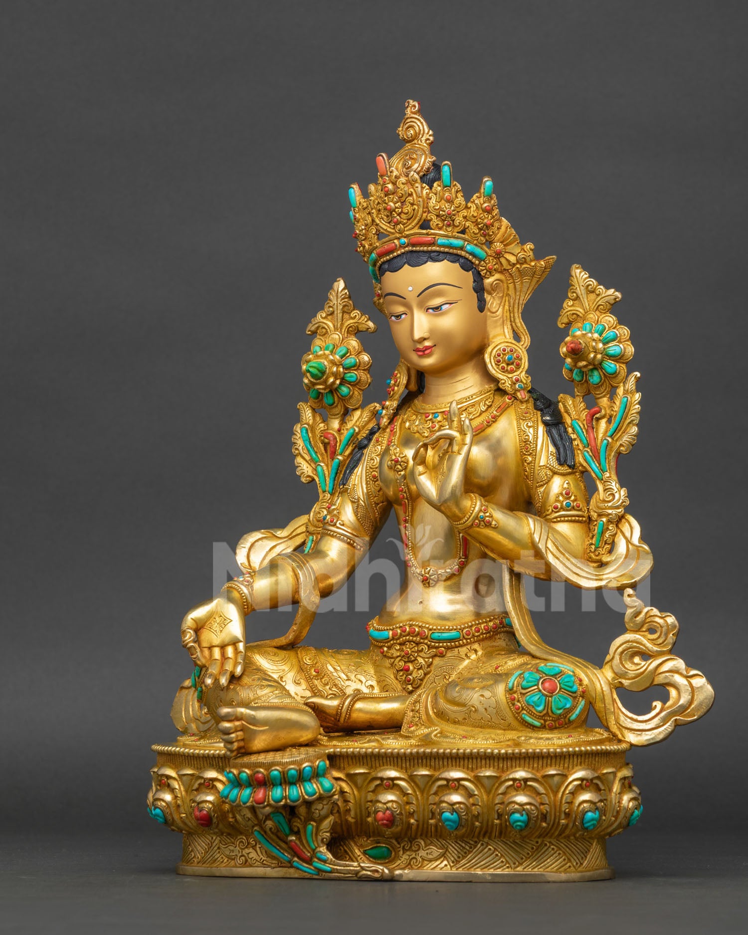 Left side view of Green Tara copper statue Bhutan showing lotus seat and robe folds