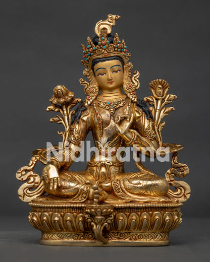 Green Tara copper statue seated on lotus throne with Utpala flower.
