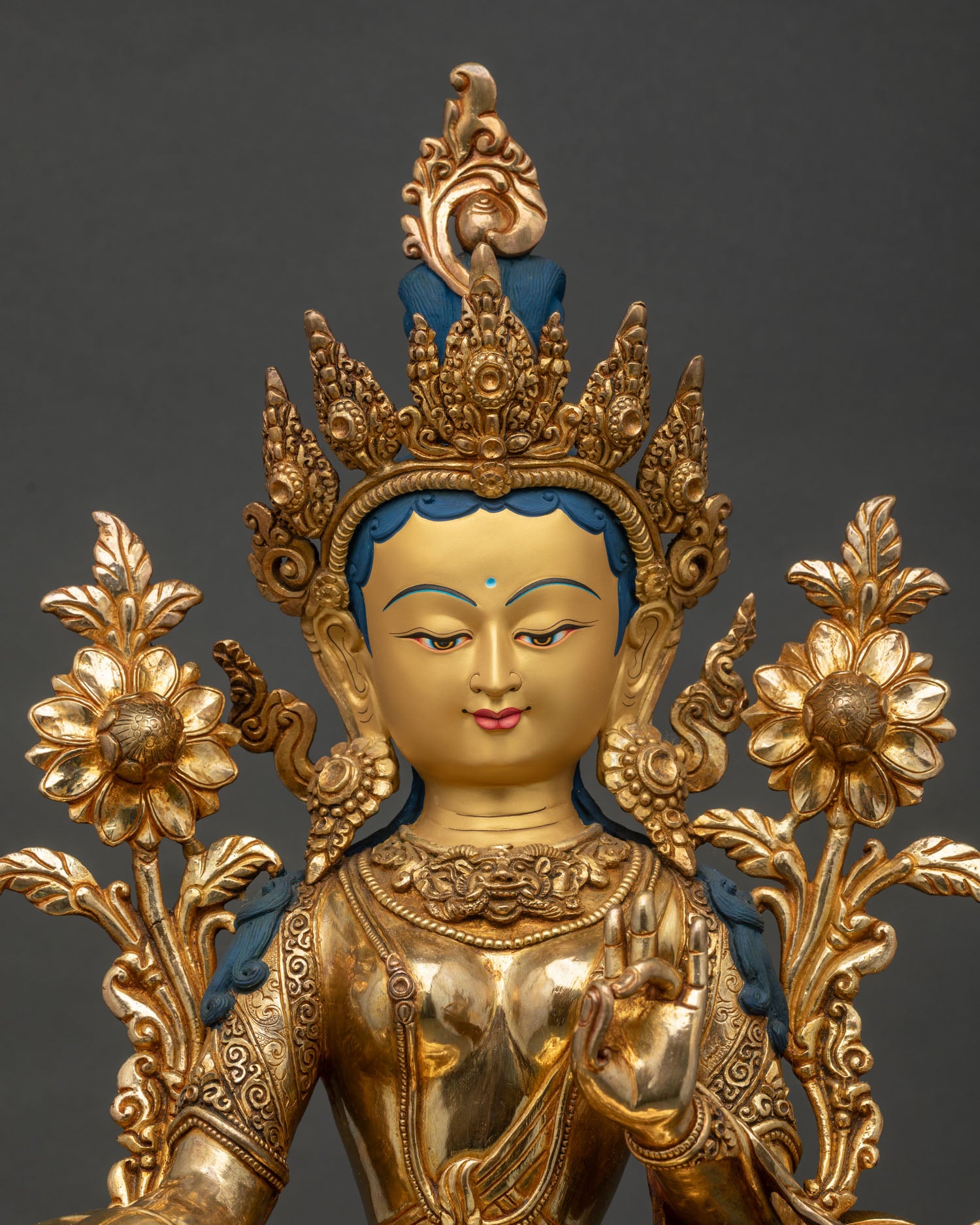 Green Tara face and upper body detail, gold-painted serene expression and ornate headdress