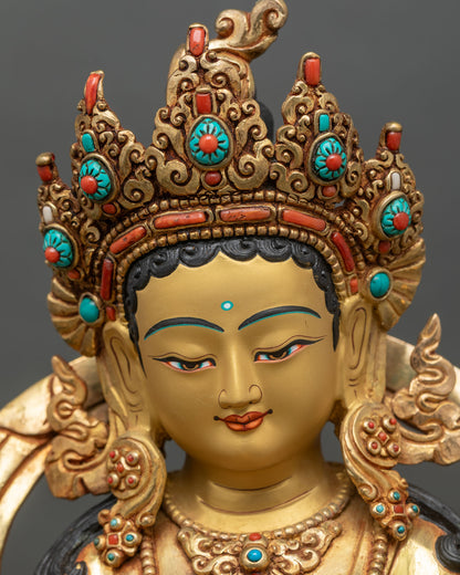 Green Tara face close up with calm gold painted expression and crown details