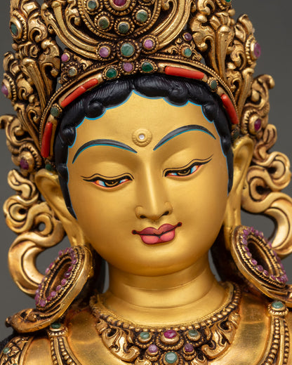 green tara face close up serene gold painted expression buddhist deity nepal sacred sculpture
