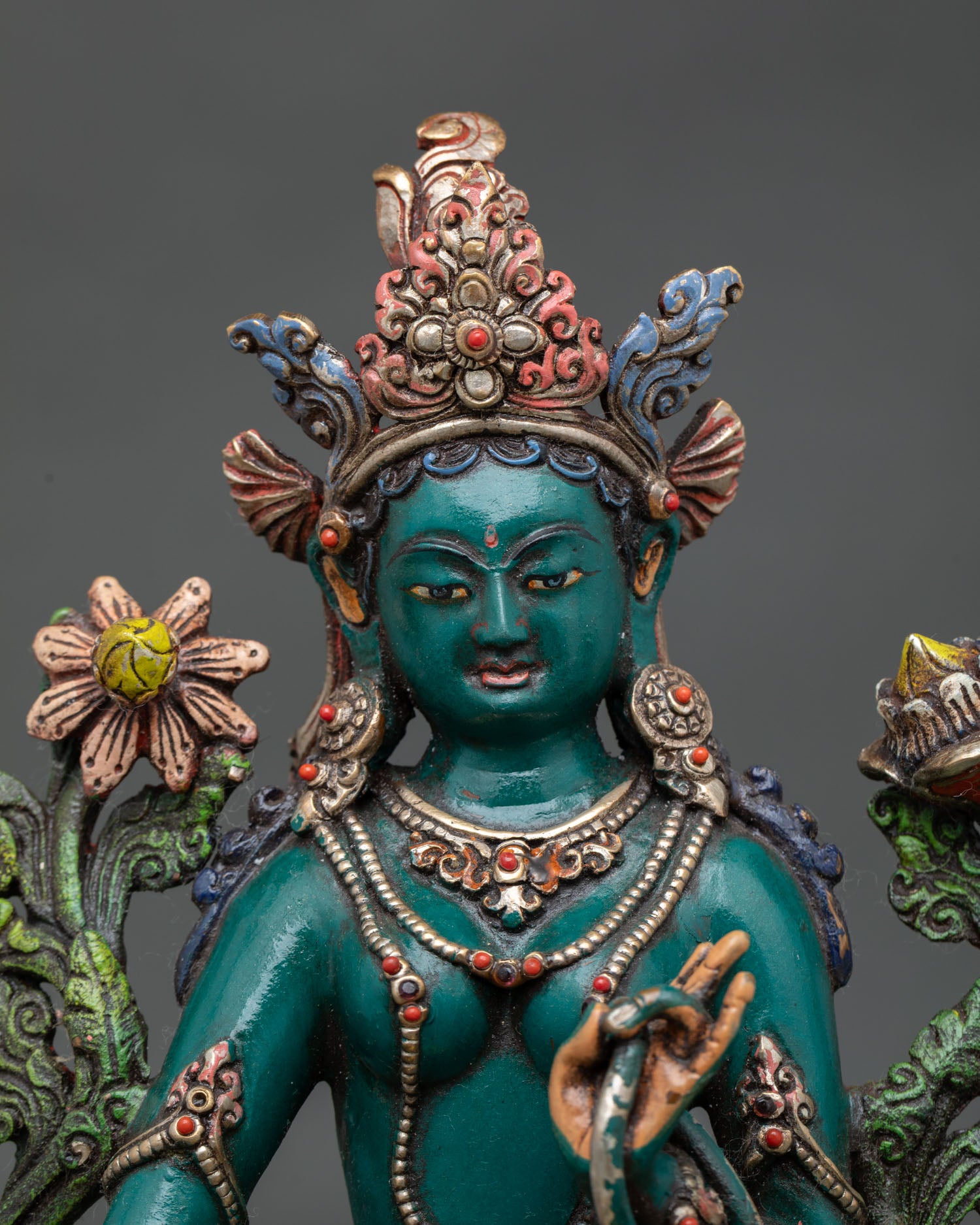 Green Tara face detail with hand-painted acrylic colors and traditional Buddhist ornamentation.