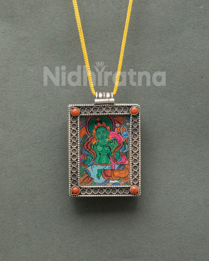 Green Tara locket handcrafted from pure silver with intricate filigree patterns and semi-precious coral stones by a Newari artist in Patan Nepal.