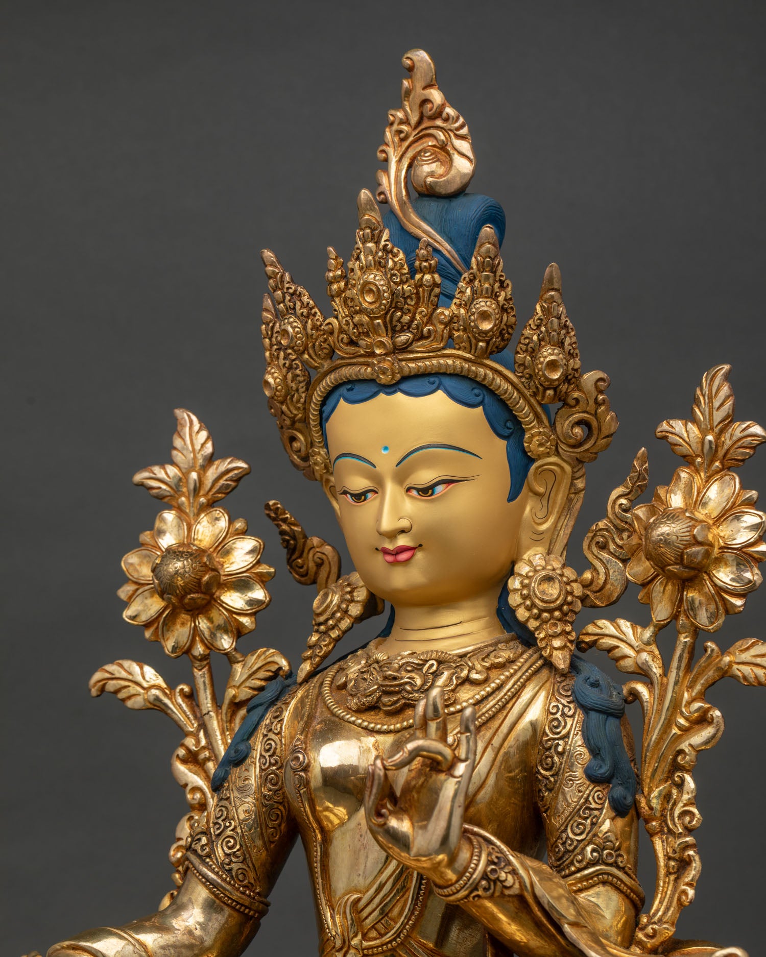 Green Tara right side profile, hand-carved robes with incised borders and lotus pedestal detail