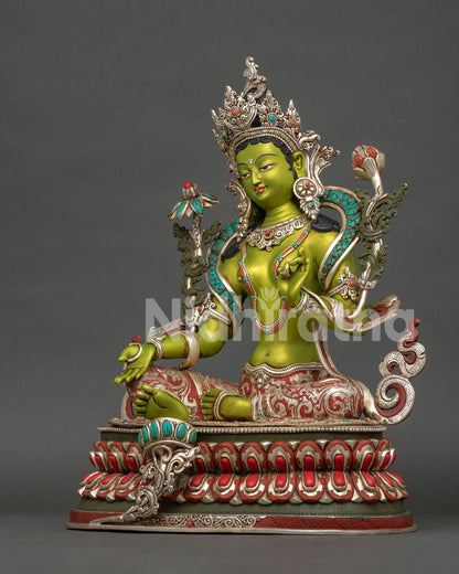Green Tara sculpture with semi-precious stone adornments, traditional craftsmanship and Buddhist goddess symbolism