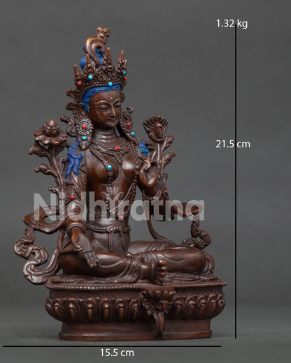 Green Tara seated gracefully on a lotus pedestal with ornate sacred jewelry