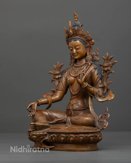 Green Tara seated gracefully on lotus pedestal with extended right leg