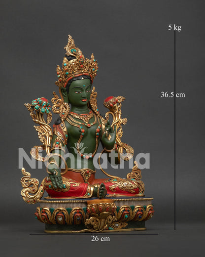 Green Tara seated in royal ease posture on a lotus flower with intricate details