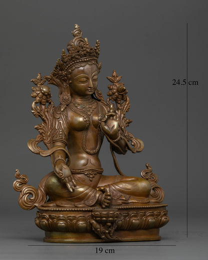 Green Tara seated gracefully on a carved lotus pedestal, holding an utpala lotus.