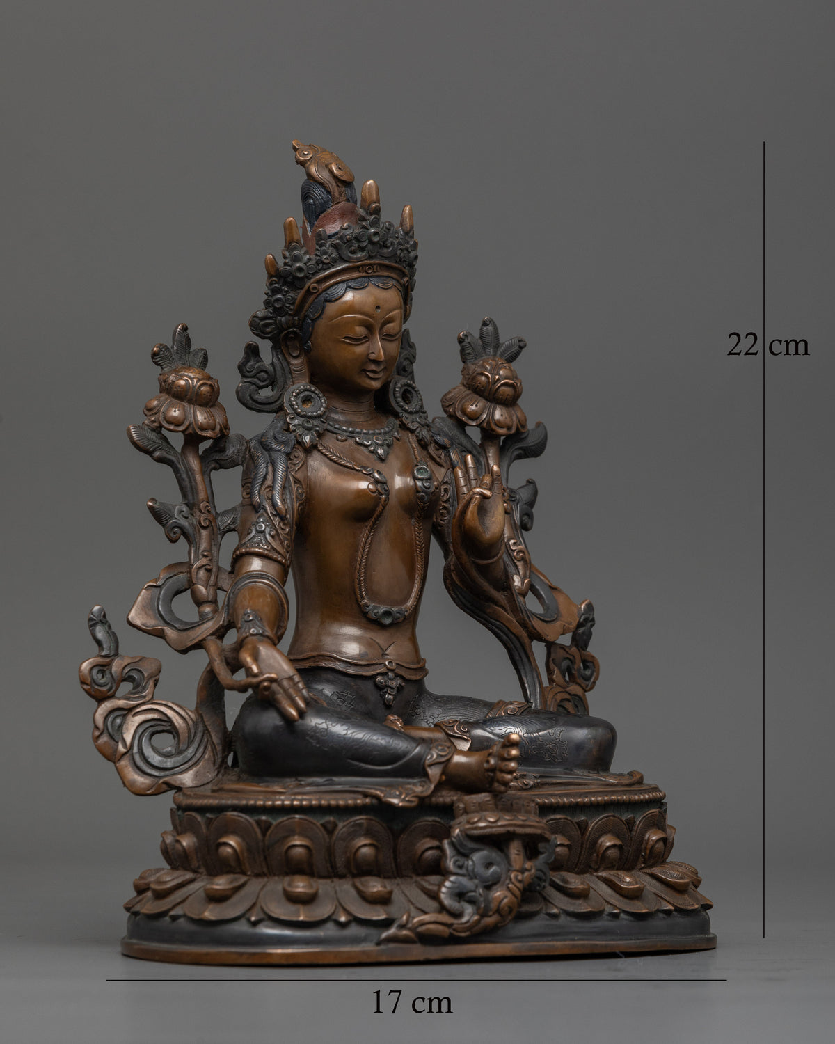 Green Tara seated on lotus pedestal with extended leg symbolizing swift compassion