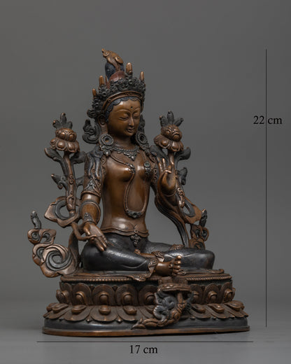 Green Tara seated on lotus pedestal with extended leg symbolizing swift compassion