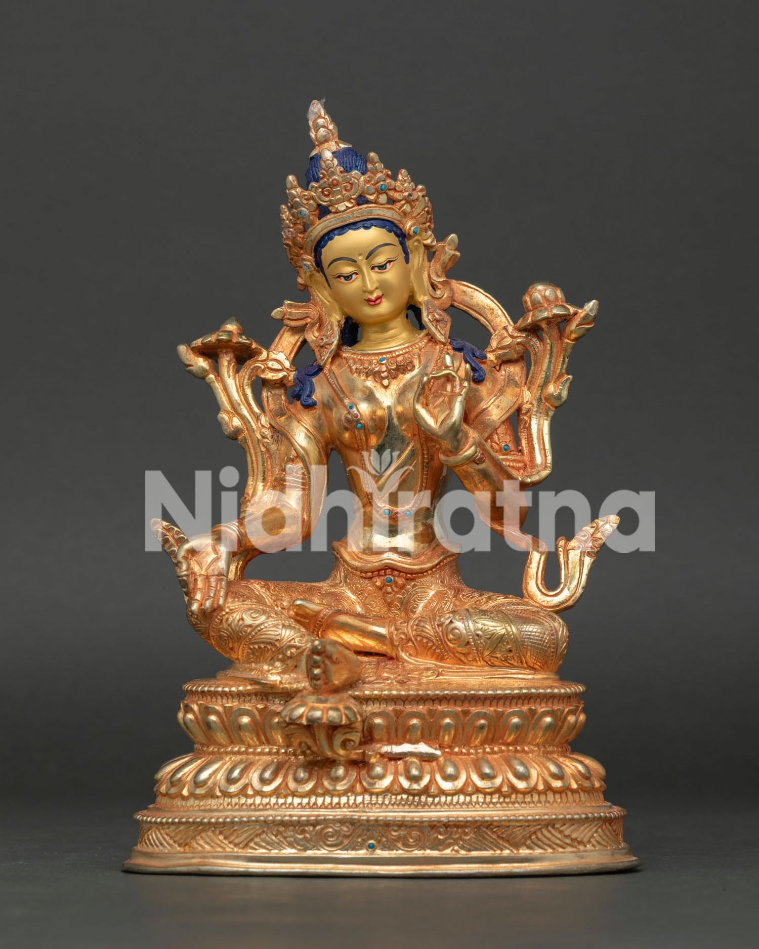 Green Tara seated on lotus throne with extended leg, handcrafted copper Buddhist statue from Nepal.