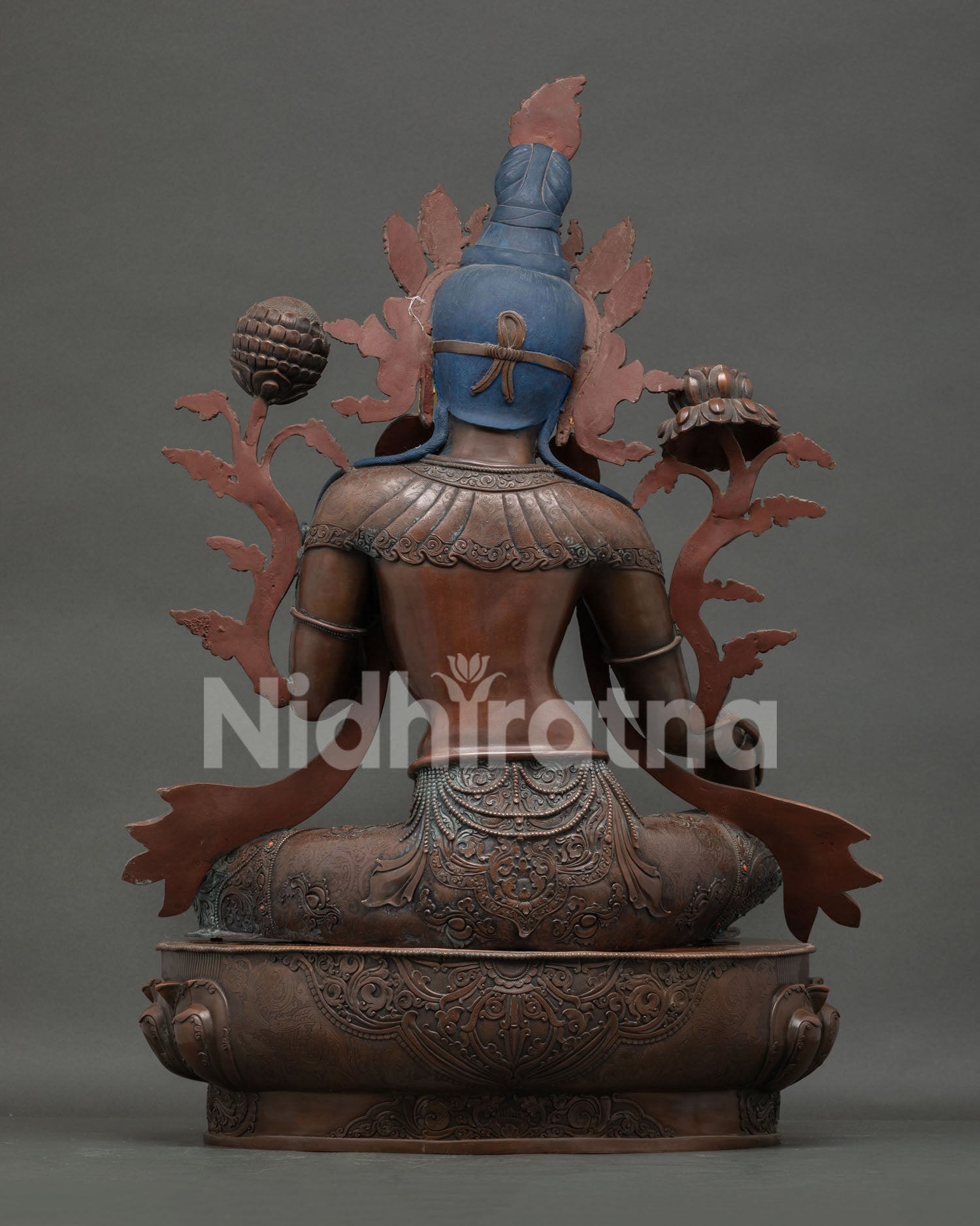 Green Tara statue back view—handmade oxidized copper Buddhist figurine with detailed carved robes
