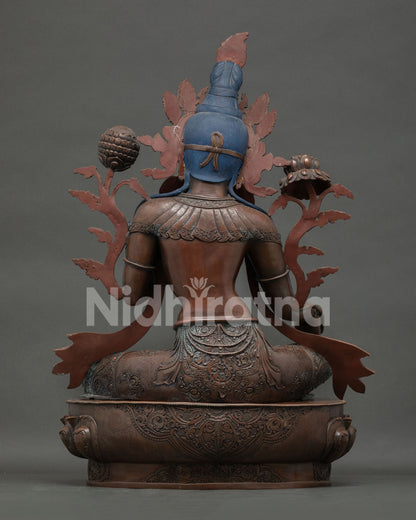 Green Tara statue back view—handmade oxidized copper Buddhist figurine with detailed carved robes