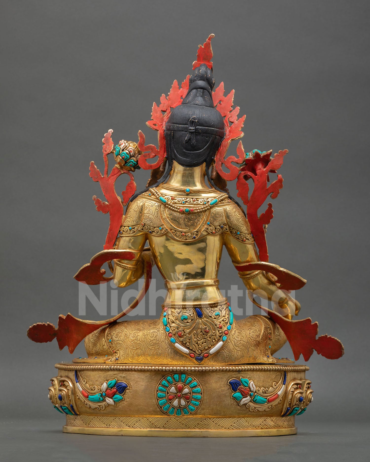 Green Tara statue back view displaying detailed copper carving, lost wax casting craftsmanship, and sacred Nepalese altar decor artistry.