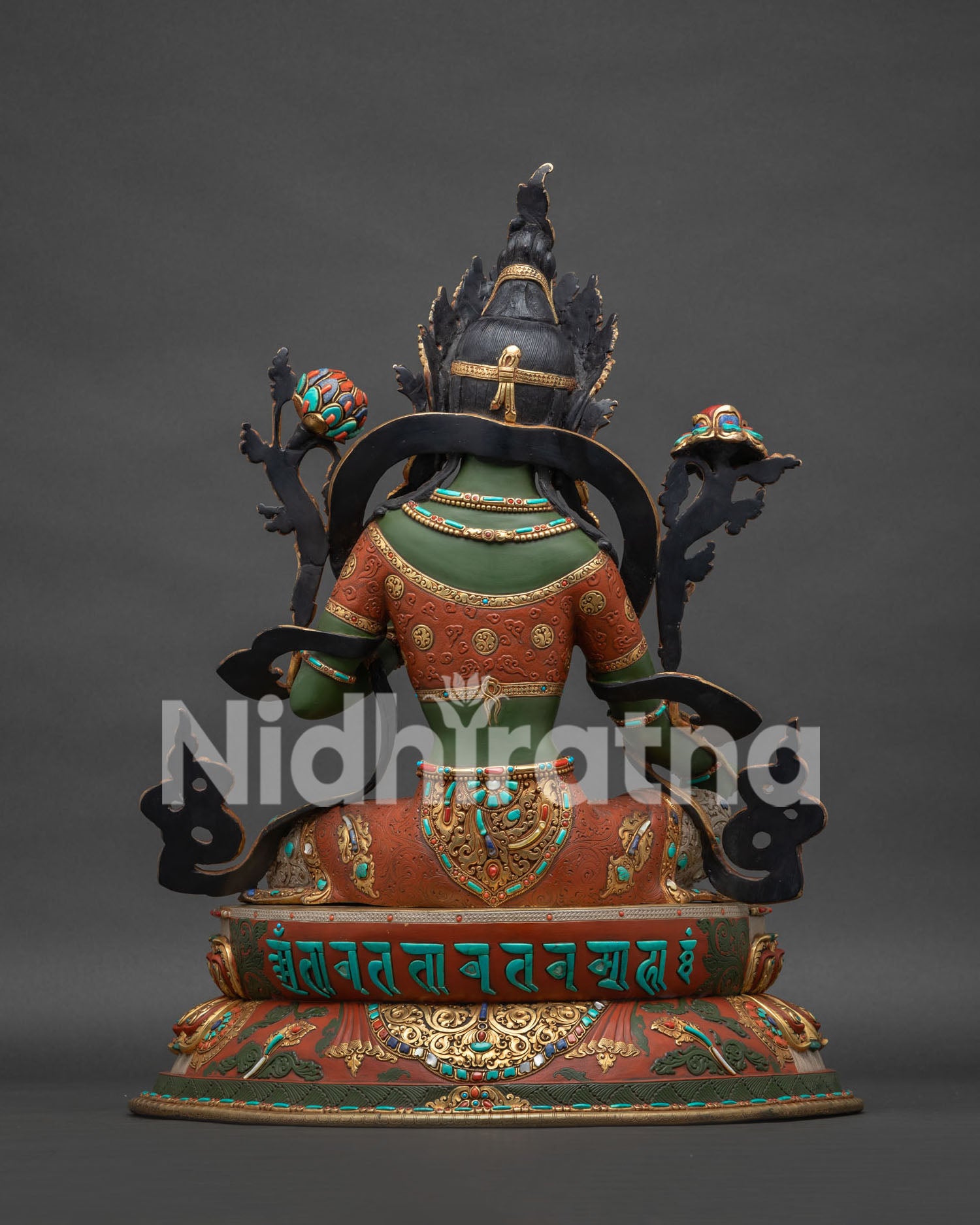 Green Tara statue back view with sacred mantra carved on base