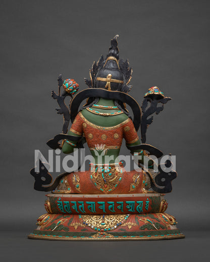 Green Tara statue back view with sacred mantra carved on base