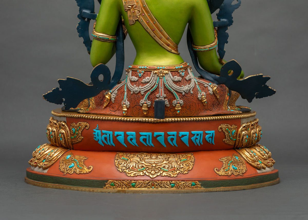 Green Tara statue base with turquoise mantra inscription and gold-gilded copper lotus details