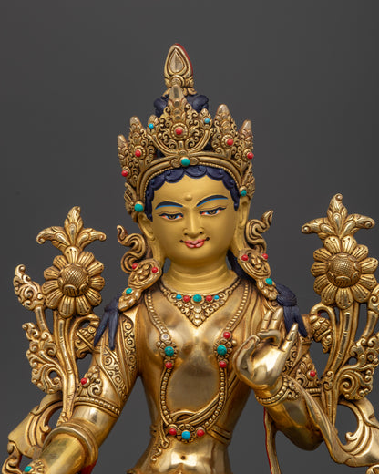 Green Tara statue close up 24K gold painted face semi precious stones Newari craftsmanship.