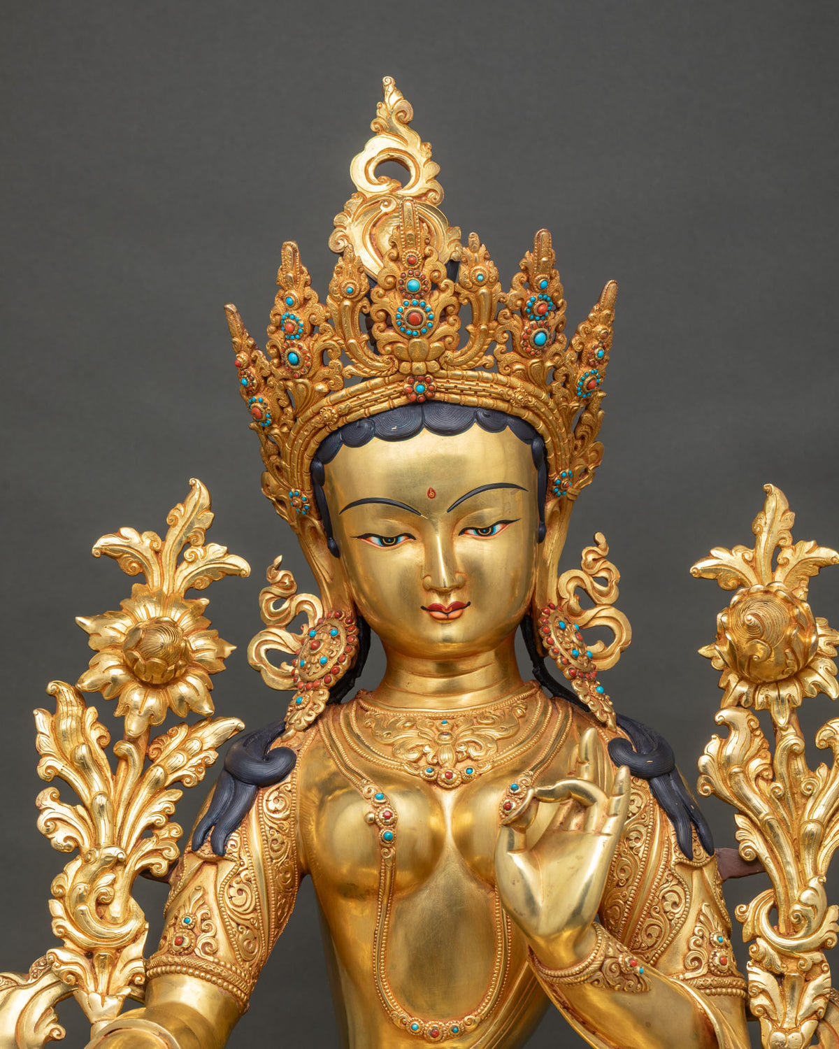 Green Tara statue close up, gold crown with turquoise and coral inlay