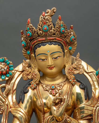 Green Tara statue close up showing gold gilding and floral carved garments