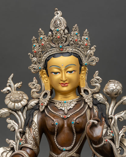 Green Tara statue close up gold painted face five jewel crown semi precious stones detail Nepal craftsmanship