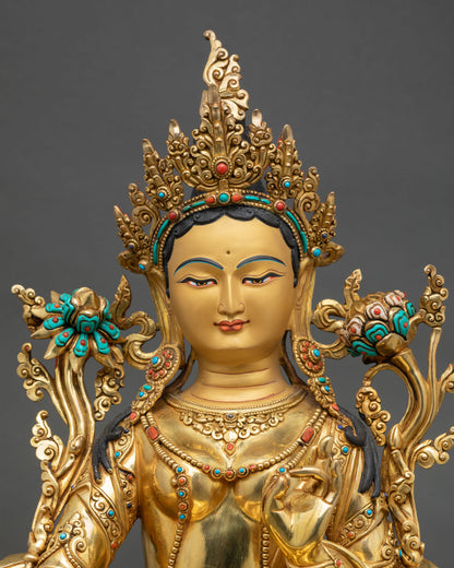 Green Tara statue close up featuring a gold painted face, intricate Newari craftsmanship, and sacred Himalayan Buddhist artistry.