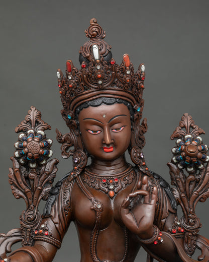 Green Tara Statue close up hand carved details silk garment semi precious stones.