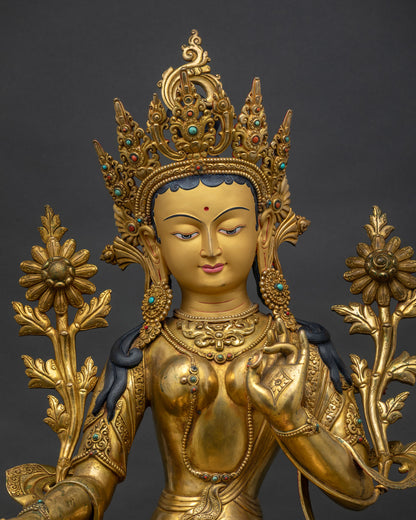 Green Tara Statue close up, handcrafted details of gold gilded Buddhist sculpture
