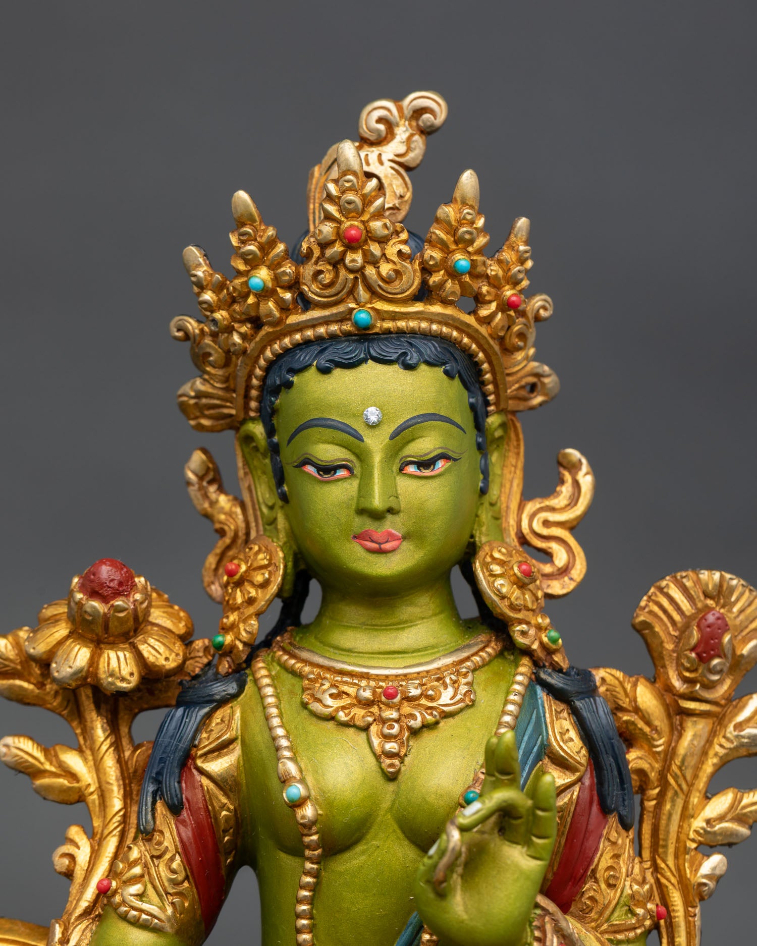 green tara statue close up handmade copper gold detailing vibrant acrylic buddhist deity art nepal