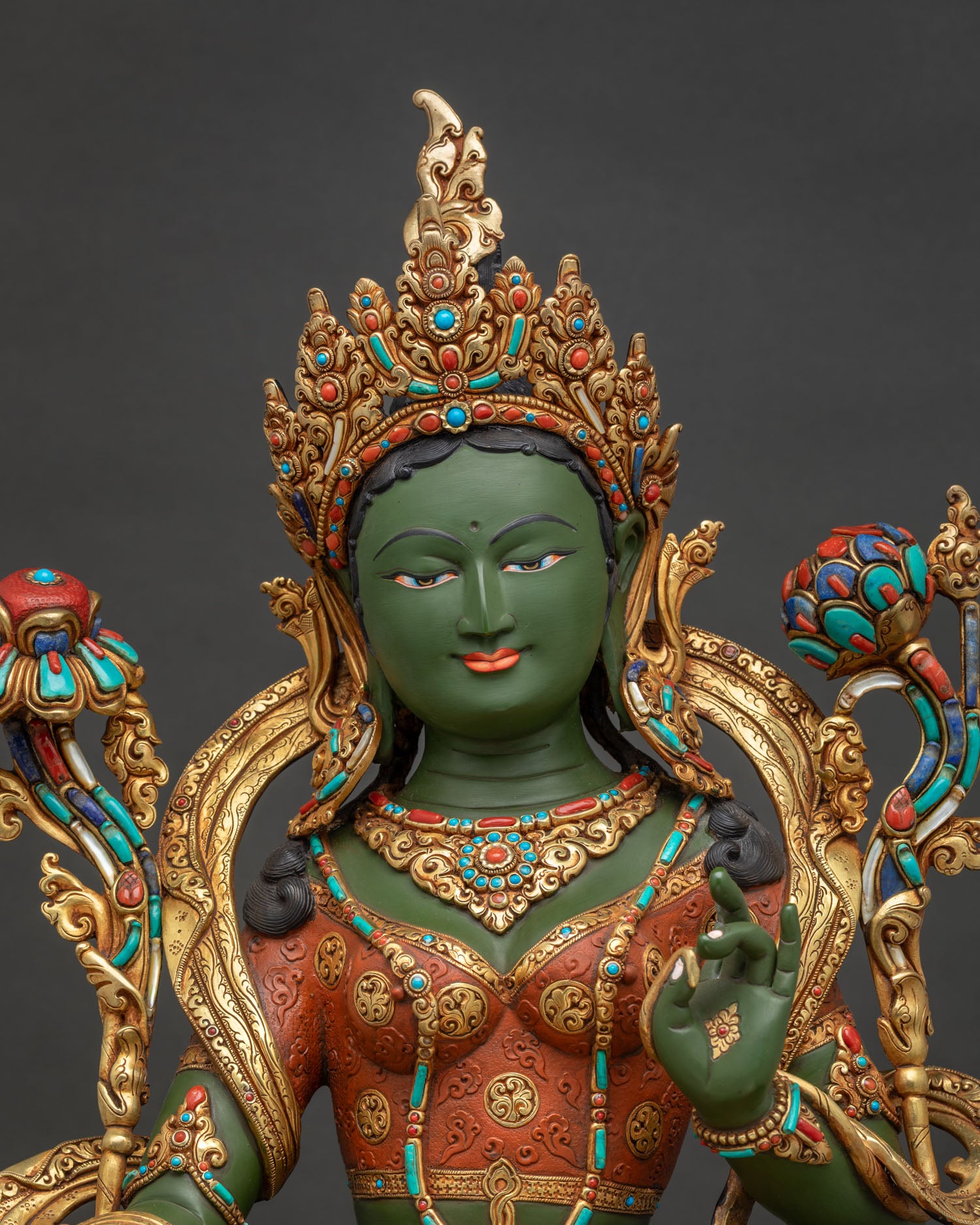 Green Tara statue close-up of gold crown and copper torso ornaments