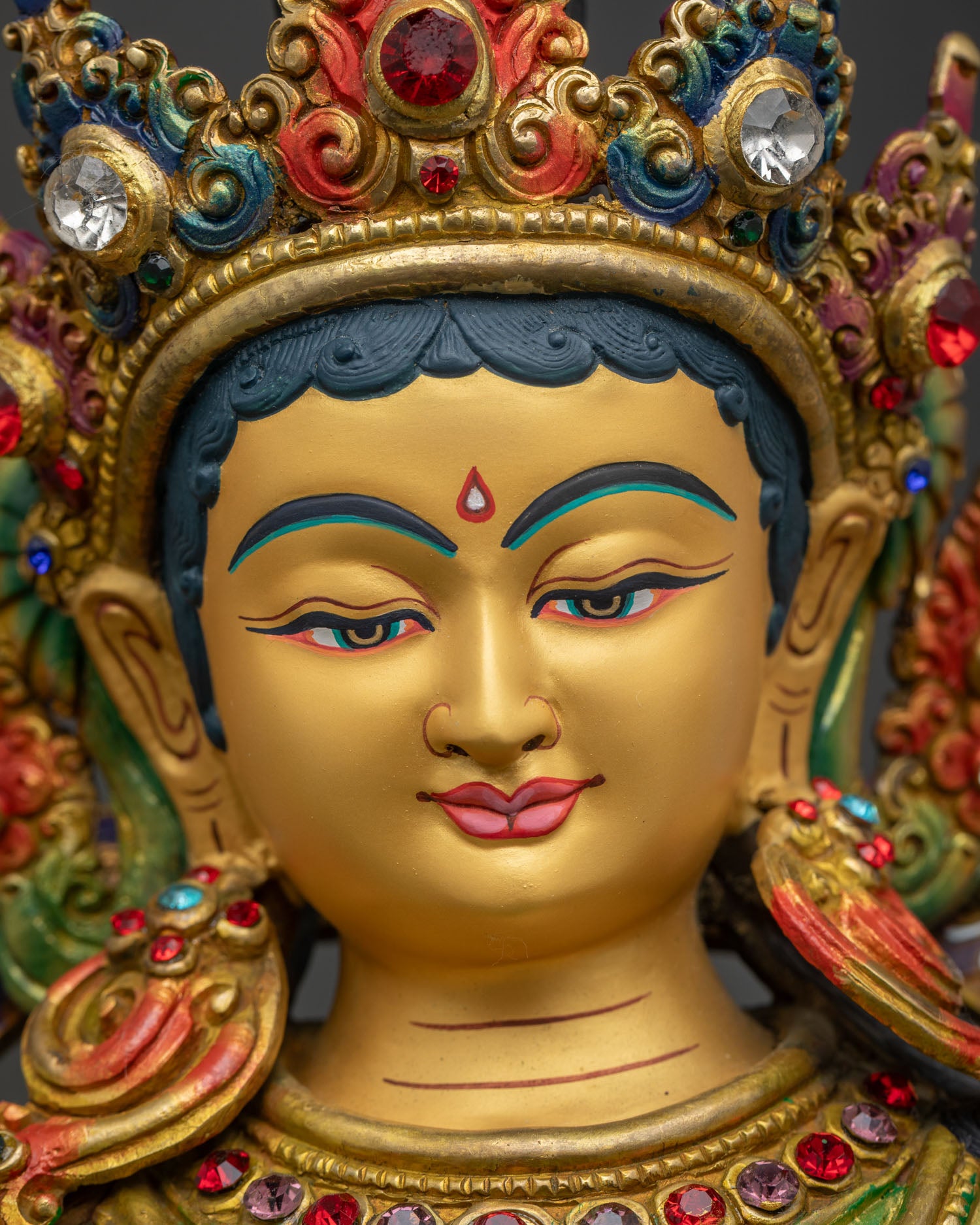 Green Tara statue detailed close up face with serene expression and fine acrylic details