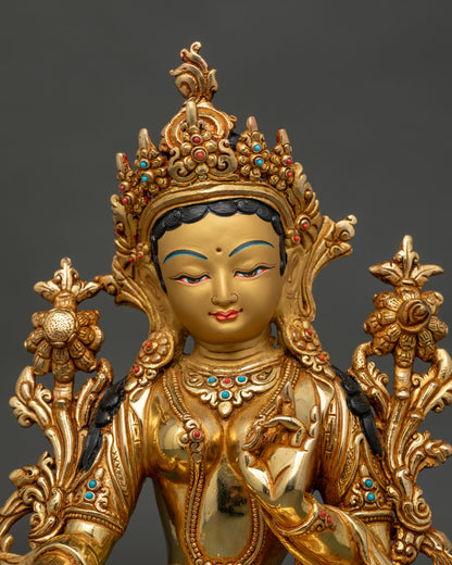 Green Tara statue detailed face with gold gilded finish.