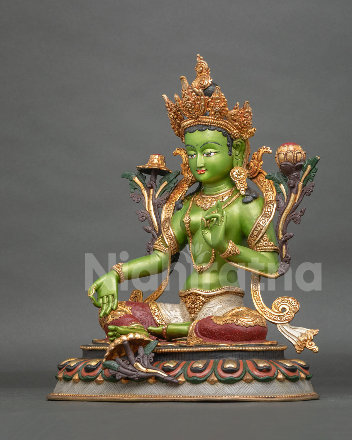 Green Tara statue detailed hands in Varada Mudra and Vitarka Mudra holding Utpala lotus stems.