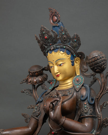 Green Tara statue face—24K gold-painted serene expression with ornate ritual headdress detail