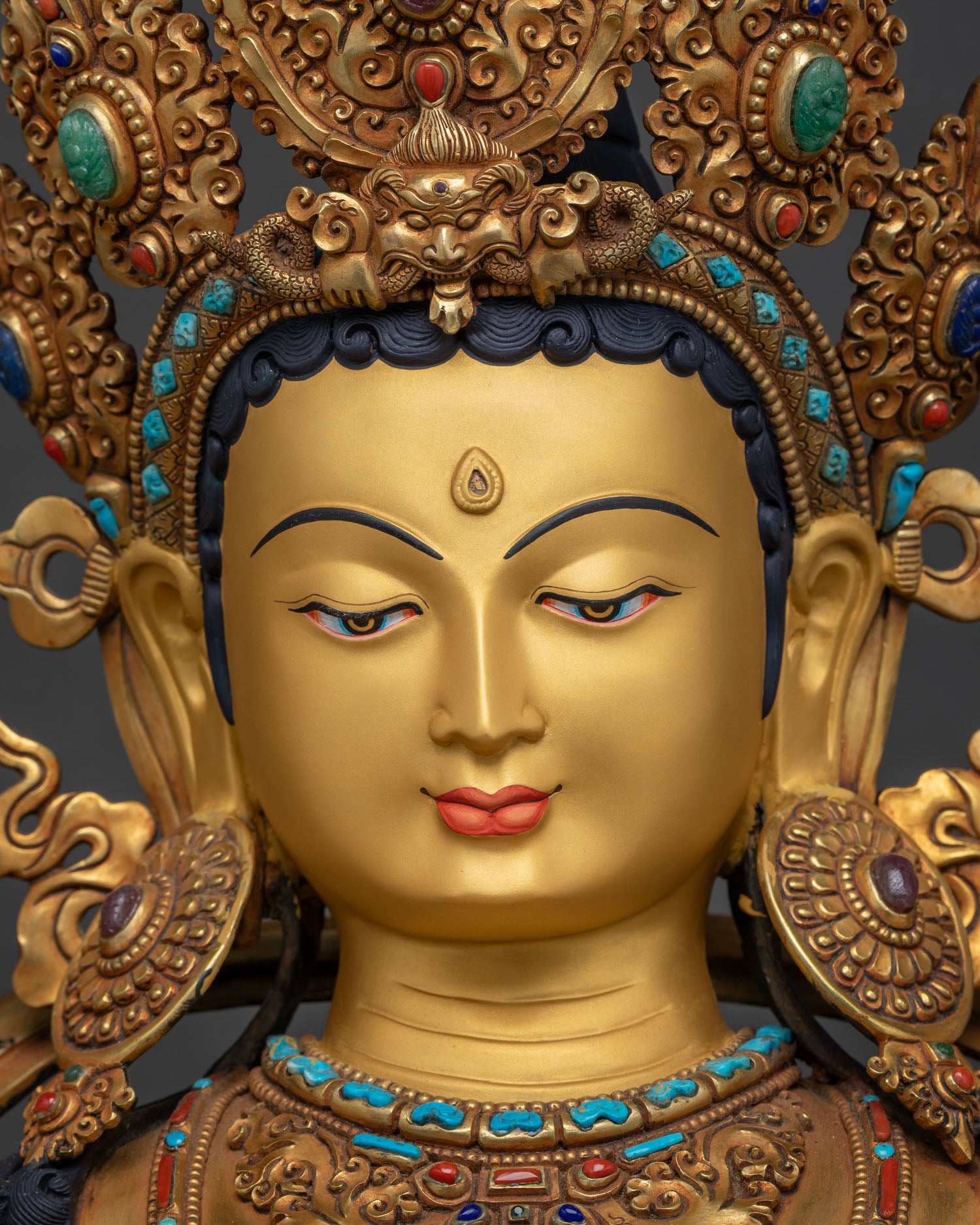 Green Tara statue face close-up — 24K gold-painted serene expression, Newari artisan Nepal