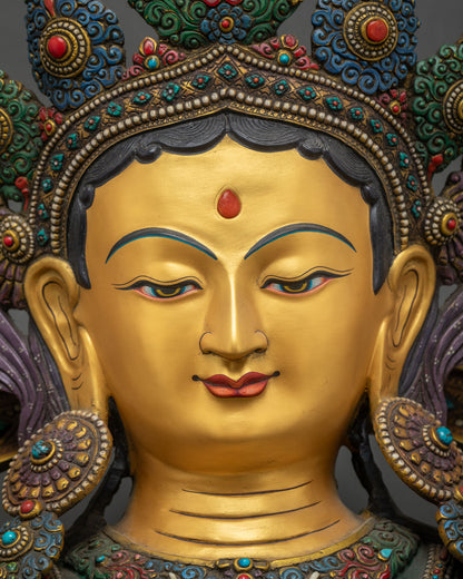Green Tara Statue face close up, gold painted serene expression detai