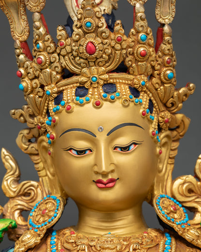 Green Tara statue face close-up, jeweled five-pronged crown, serene expression, 24K gold Nepal